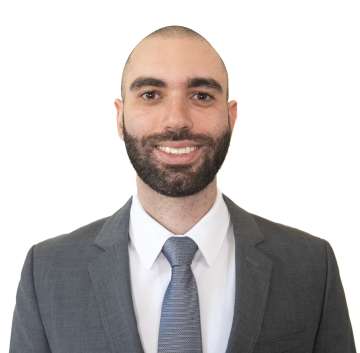 Nicholas Kopoosian in a business suit, smiling at camera