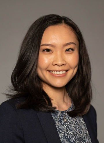 Head shot of Kristine Khieu in business attire, smiling at camera