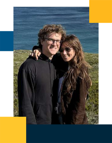 Andrew Roney and partner with grass and ocean in the background