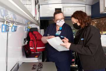 Team members discussing care in the van
