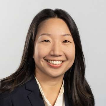 Head shot of Jessica Lam, MD, PhD in business attire, smiling at camera