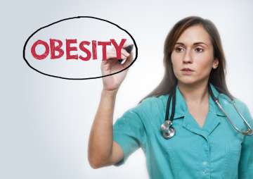 Nurse writing obesity on a board