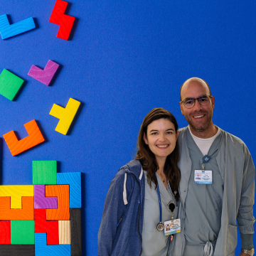 Informatics leads in front of blue photo with falling puzzle pieces