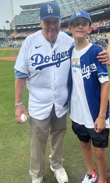 Dr. John Glaspy and his grandson Braden enjoyed some time on the field before a recent Dodgers game. (Photo by Catherine Boyer)
