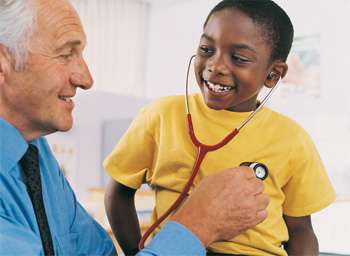 Doctor using stethescope on child