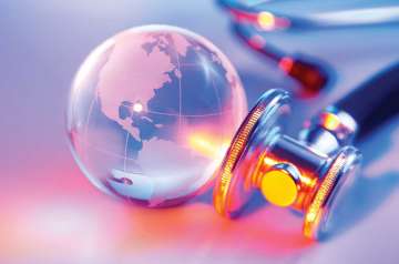 Stethoscope and glass globe on table top