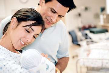 Parents smiling at newborn