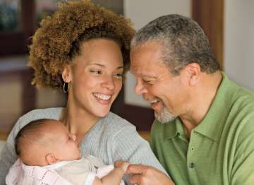 Mother holding child and smiling