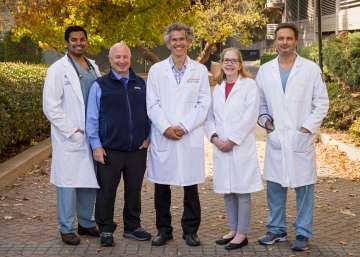 Pediatric Cardiology doctors standing outside smiling