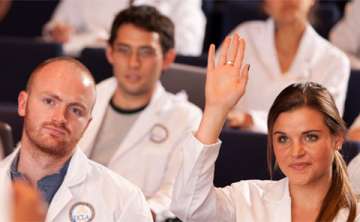 GMIG student raising her hand during a lecture