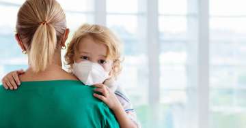 Mom carry son with mask on