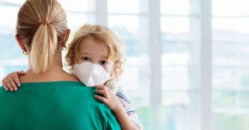 Mom carry son with mask on