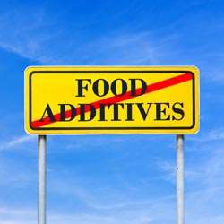 Sign that says "Food Additives" with a red line through it 