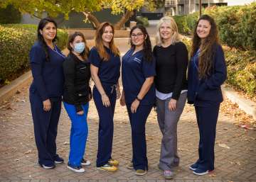 Group of nurses standing together smiling outdoors