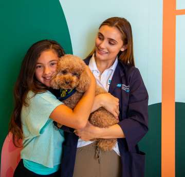 PAC dog with partner and girl