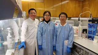 Rong Lu and Dian Cai with Quang Tran, Lab Staff