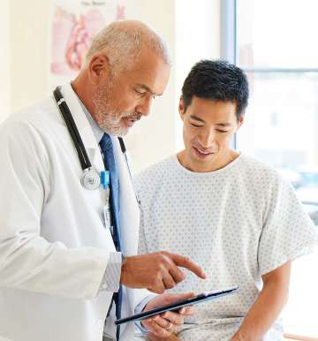 Younger male patient with older male doctor
