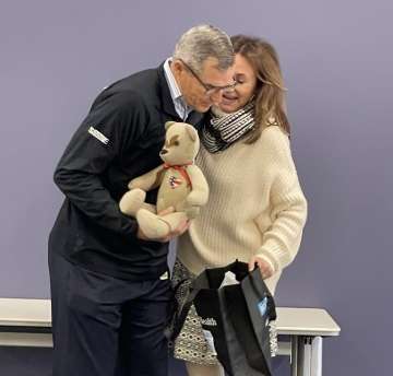 Gen. Michael Linnington holds an Honor Bear, presented by Operation Mend Executive Director Dr. Jo Sornborger, PsyD.