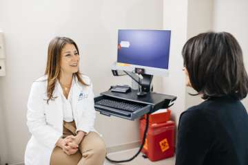 Dr. Sanaz Memarzadeh with a patient. 