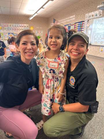 Young girl Lucy Cadenas with her two moms