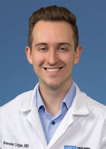 Head shot of Brendan Colgan MD, in white coat, smiling at camera