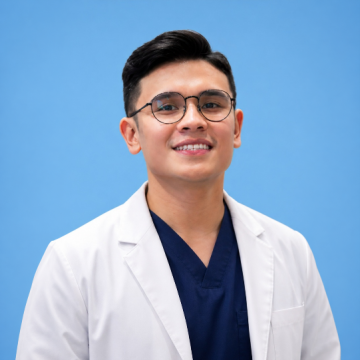 Ven Requejo wearing a white lab coat over navy scrubs against a blue background