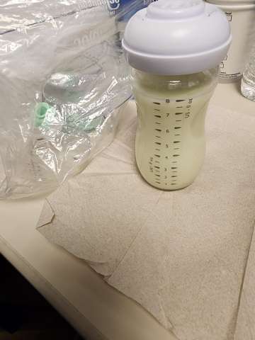 Shradha Khadge, MD shows full bottle of pumped milk in bottle