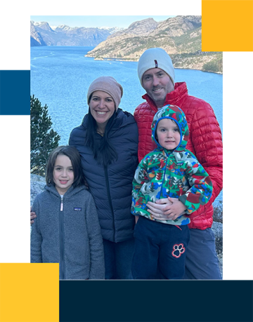 Errol Philip with family outdoors and lake in the background