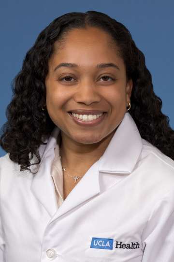 Head shot of Rehana Persaud, MD, MS in white coat, smiling at the camera