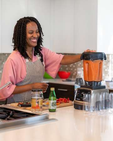 Dr. Kymora Scotland prepares food in a blender