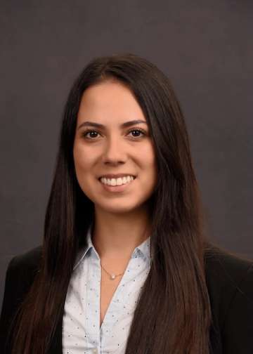 Head shot of Karen Kikuta, MD in business attire, smiling at camera