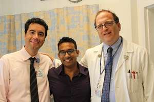 Fellows standing in hospital room with Doctor