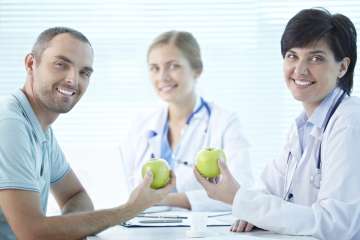 Patient and doctor holding apples
