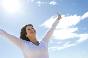 Woman outside with arms up