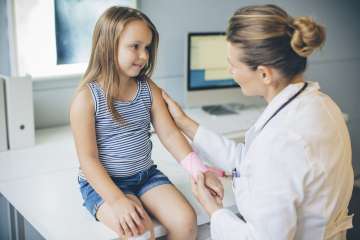 Doctor performing checkup on child