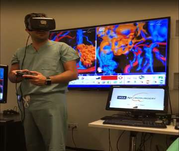 Doctor wearing VR headset with a screen and a computer behind him