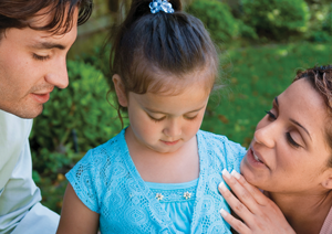 parents speaking to a child outside