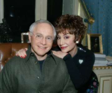 Stewart and Lynda Resnick smiling in a seated portrait