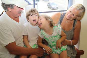 Children with cerebral palsy laughing with their parents