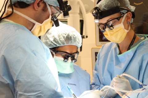 Drs. Richard Everson, Shivani Baisiwala, and Sophie Peeters operating