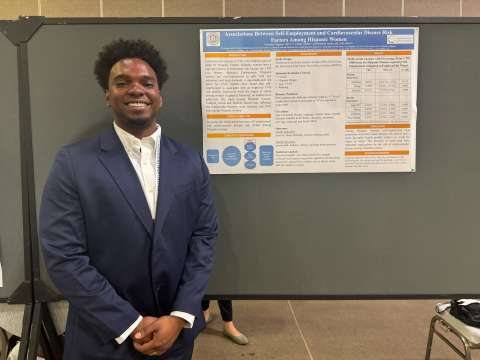 Dr. Ferguson in front of his poster presented at APHA