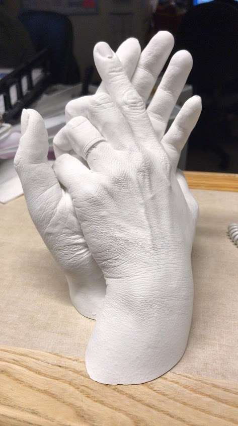 A hand mold capturing a couple holding hands