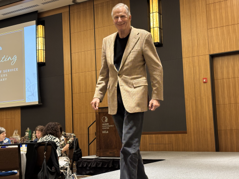 A man participates in the UCLA Thrift Shop fashion show.
