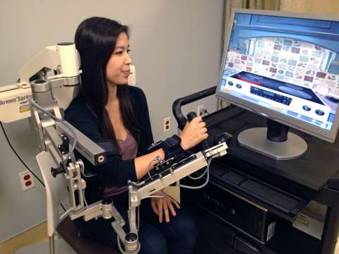 Woman siting in machine at spine center