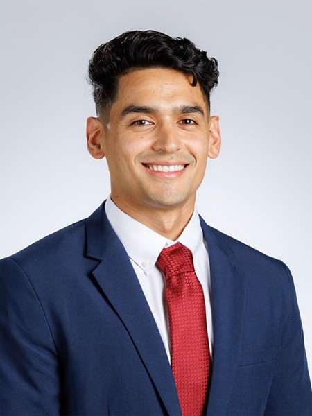 Dr. David Alfaro smiling in a blue suit
