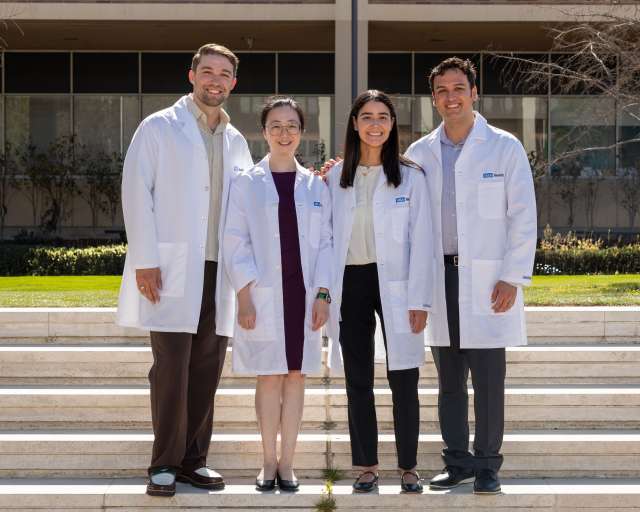 Pathology Chief Residents in white lab coats standing next to each other on stairs