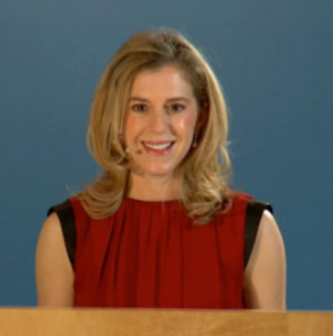 Woman on stand giving a conference presentation about Research That Matters