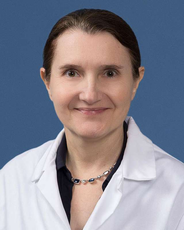 Sandra Orsulic, PhD in a white lab coat