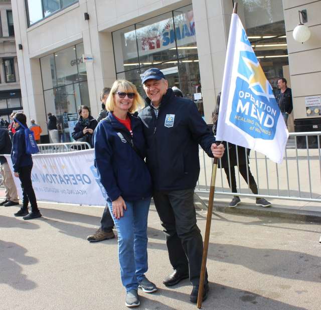 Donors, Judy and Dan Soper posing and holding an Operation Mend flag