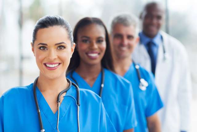 Four people of different racial and gender identies, all wearing stethoscopes.